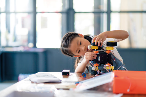 asian child working building robot
